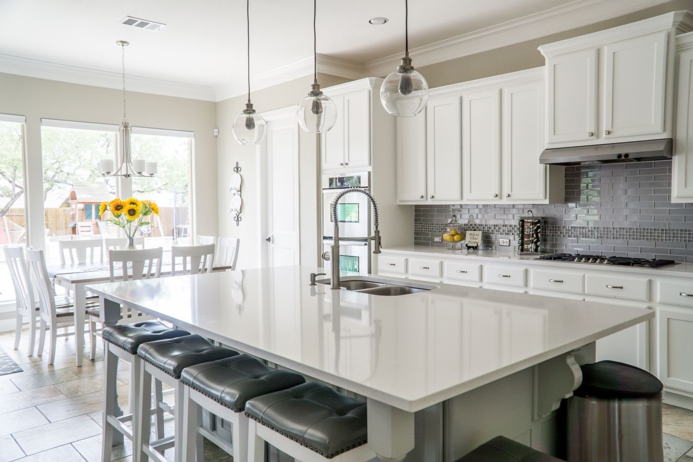 A bright, uncluttered kitchen with clear worktops and a route around the island